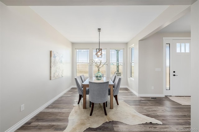 dining room featuring dark hardwood / wood-style floors and an inviting chandelier