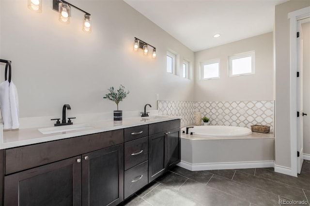 bathroom with vanity, tile patterned floors, and a tub to relax in