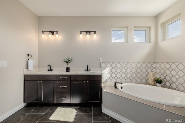 bathroom with vanity, tile patterned flooring, and a tub