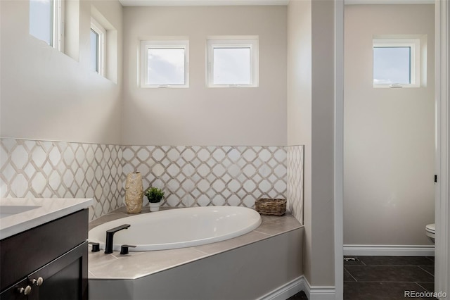 bathroom with vanity, toilet, a bathing tub, and tile patterned flooring