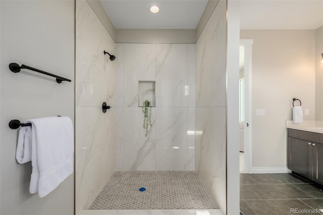 bathroom with vanity and tiled shower