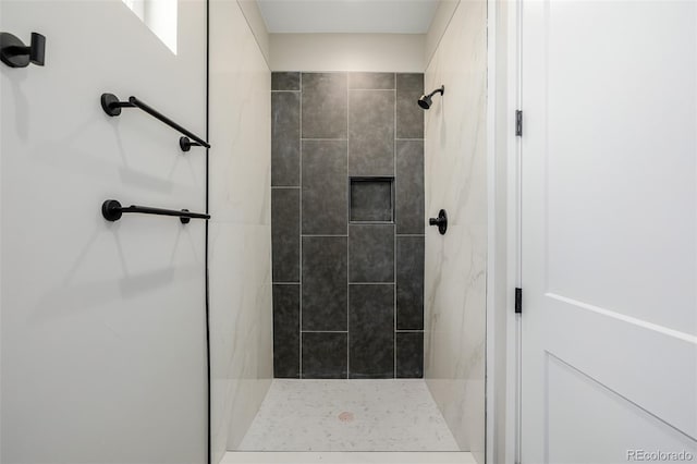 bathroom with a tile shower