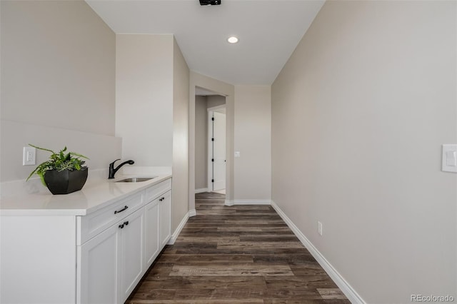 hallway featuring sink and dark hardwood / wood-style floors