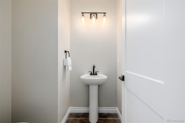 bathroom with wood-type flooring and sink