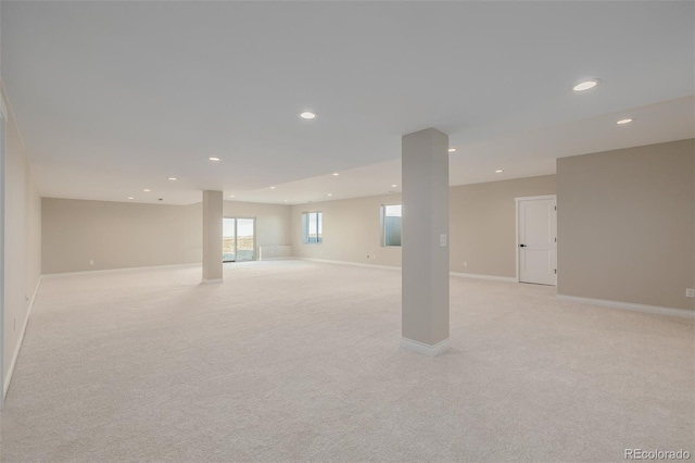 basement featuring light colored carpet