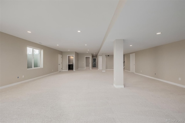 basement featuring light colored carpet