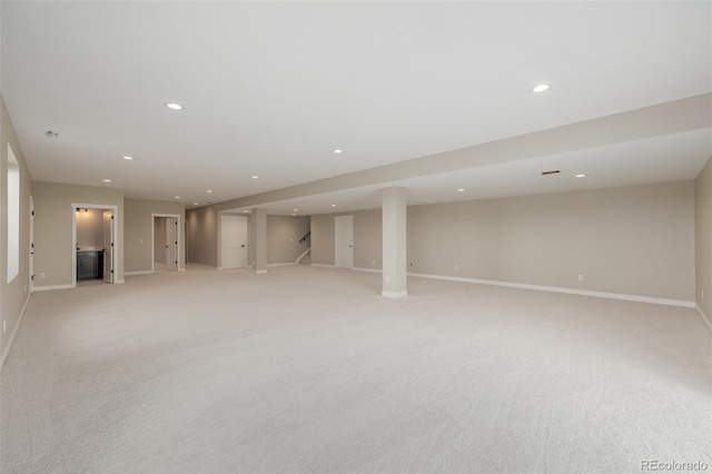 basement featuring light colored carpet