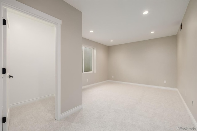 unfurnished room featuring light colored carpet