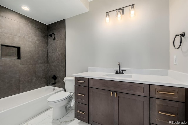 full bathroom featuring tiled shower / bath, vanity, and toilet