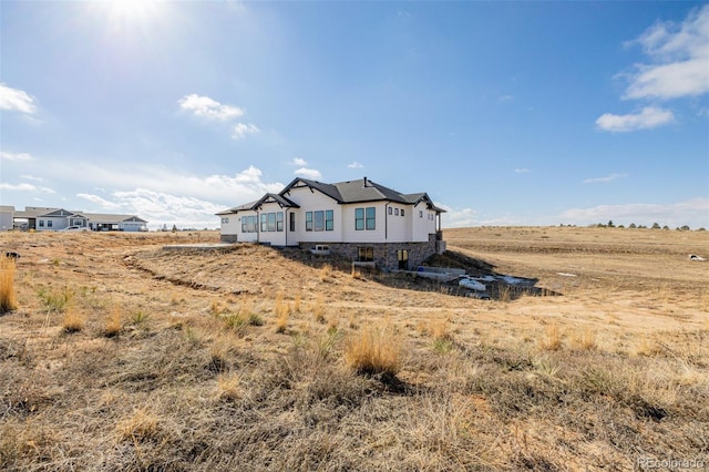 view of home's exterior featuring a rural view