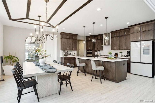dining space with light wood finished floors, a chandelier, and recessed lighting