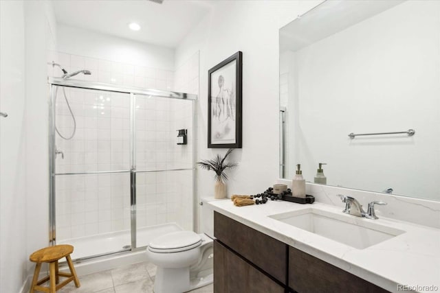 bathroom with a shower stall, toilet, tile patterned floors, vanity, and recessed lighting