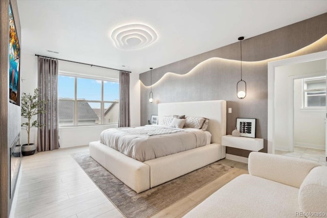bedroom with wood finished floors and baseboards