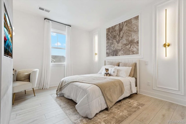 bedroom with light wood finished floors