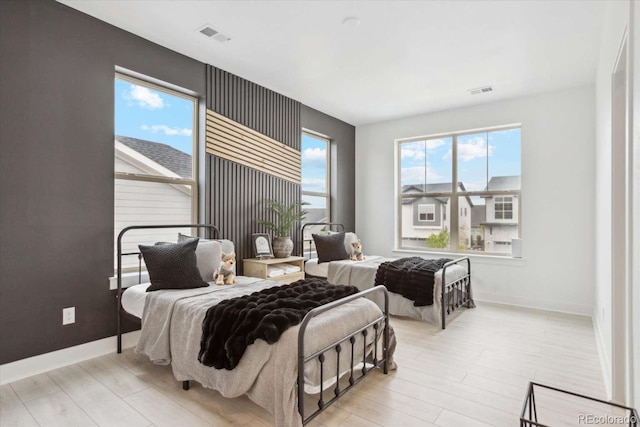bedroom with wood finished floors and baseboards