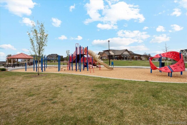 communal playground featuring a gazebo and a lawn