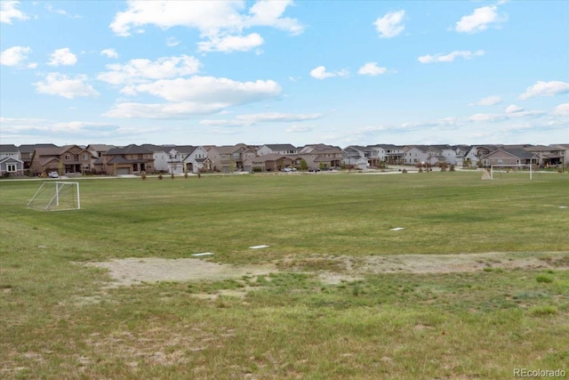 view of home's community featuring an area for sports and a residential view