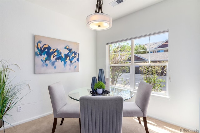 dining space with light colored carpet