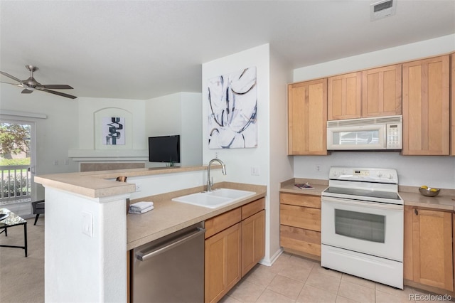 kitchen with ceiling fan, sink, kitchen peninsula, white appliances, and light tile patterned floors