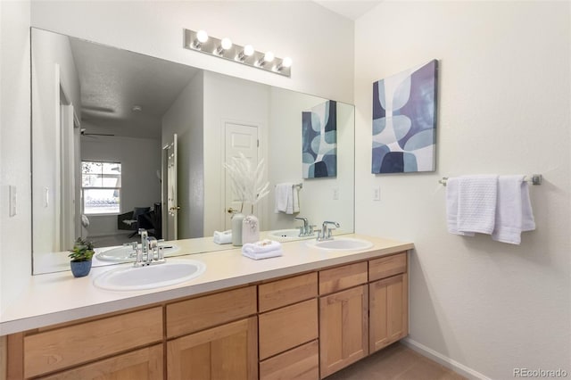 bathroom with ceiling fan and vanity