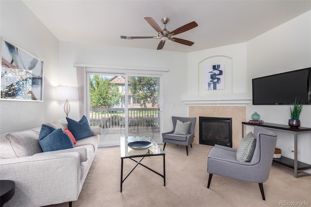 living room with light carpet, a fireplace, visible vents, and ceiling fan