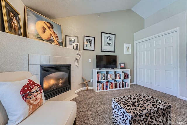 18084 Becket Dr, Parker, CO 80134 - carpeted living area featuring a tile fireplace and vaulted ceiling