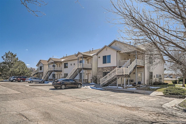 18084 Becket Dr, Parker, CO 80134 - view of property with stairs, uncovered parking, and a residential view
