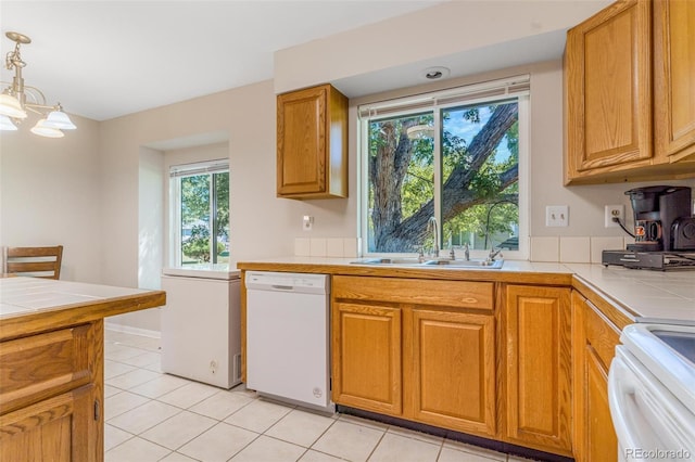 7887 York St Unit 1, Denver, CO 80229 - kitchen with dishwasher, tile countertops, stove, and hanging light fixtures