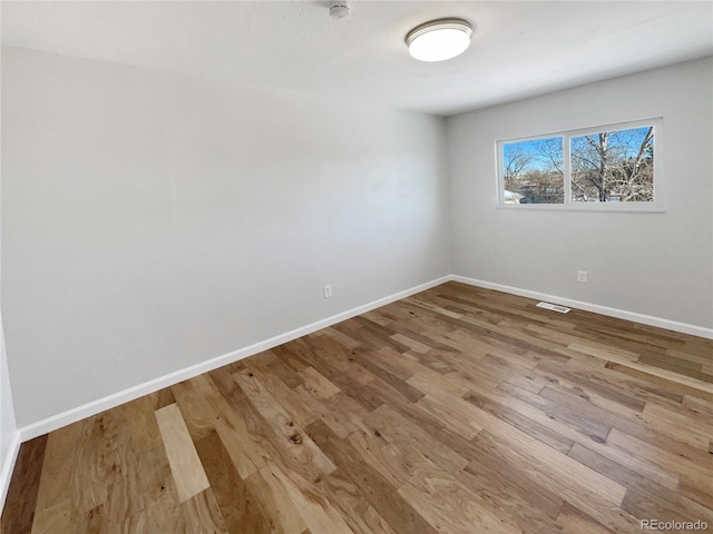 spare room with light hardwood / wood-style flooring