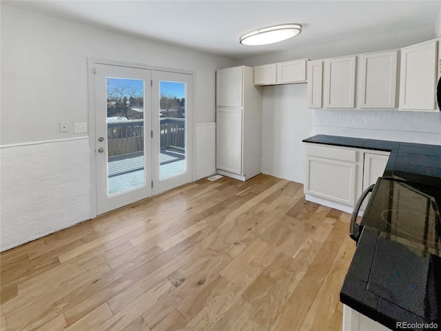 kitchen featuring white cabinets and light wood-type flooring