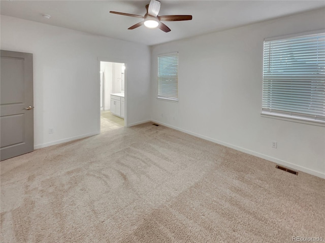 unfurnished bedroom with light carpet, baseboards, and visible vents