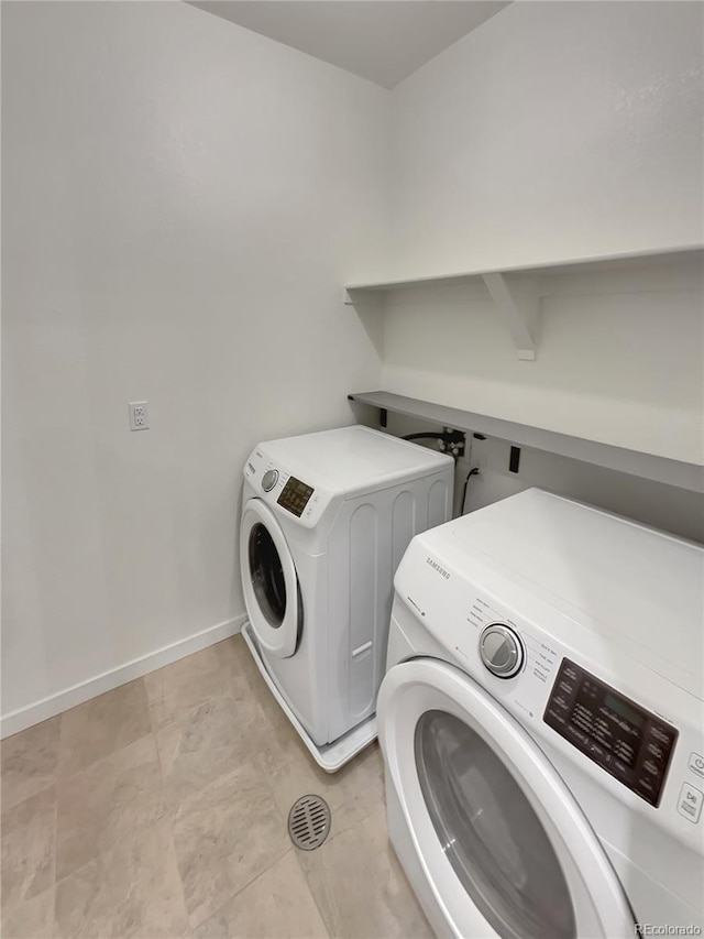 laundry room featuring laundry area, washer and clothes dryer, and baseboards