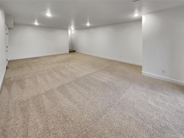 empty room with recessed lighting, visible vents, baseboards, and light colored carpet