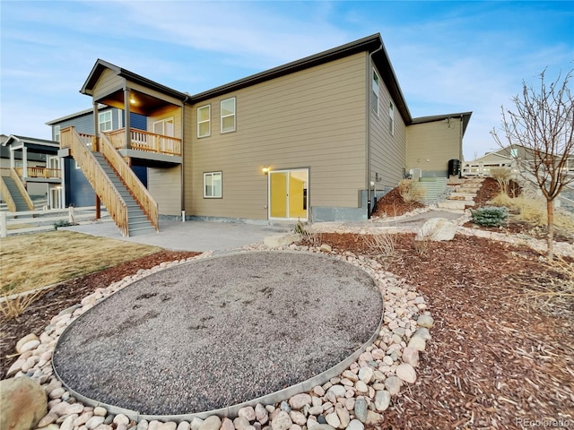 rear view of property with a patio area and stairway