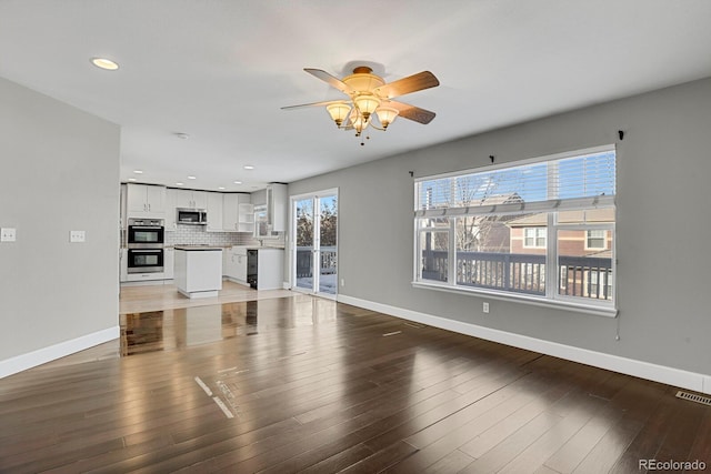 living room with wood-type flooring and ceiling fan