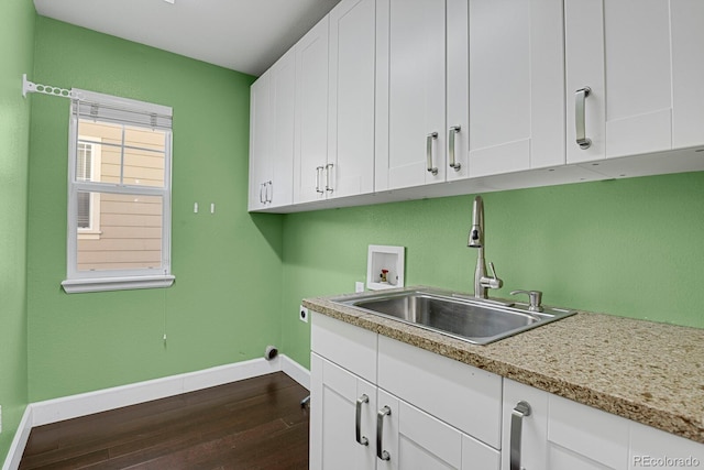 laundry area featuring hookup for an electric dryer, washer hookup, dark hardwood / wood-style flooring, cabinets, and sink