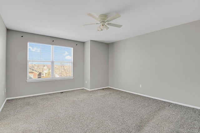 spare room featuring carpet floors and ceiling fan