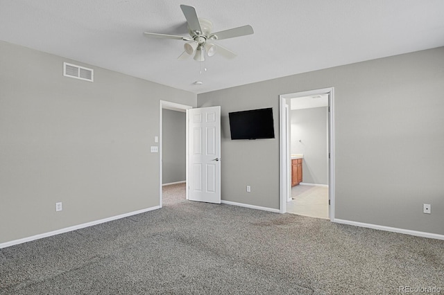 unfurnished bedroom with connected bathroom, ceiling fan, and carpet floors