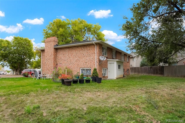 back of property featuring a lawn