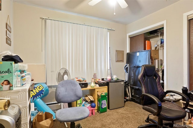 carpeted office space with ceiling fan