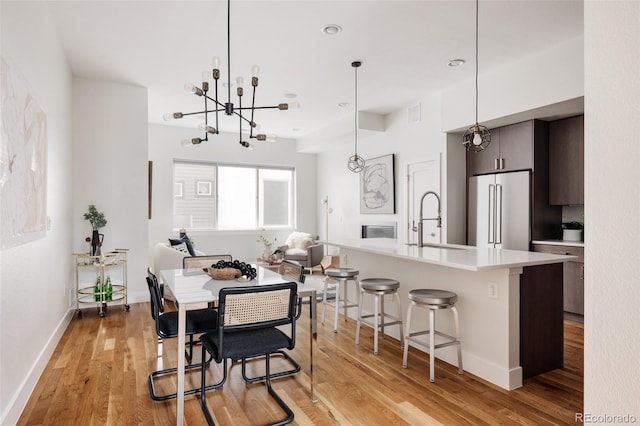 3308 W 17th Ave, Denver, CO 80204 - dining area with a chandelier, light wood-style flooring, and recessed lighting