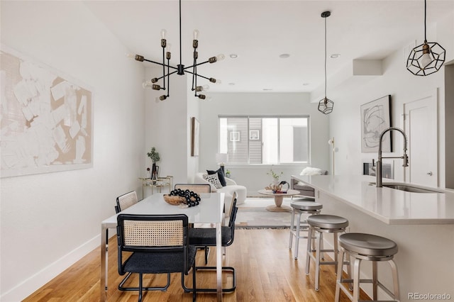 3308 W 17th Ave, Denver, CO 80204 - dining room with light wood finished floors, a chandelier, and recessed lighting