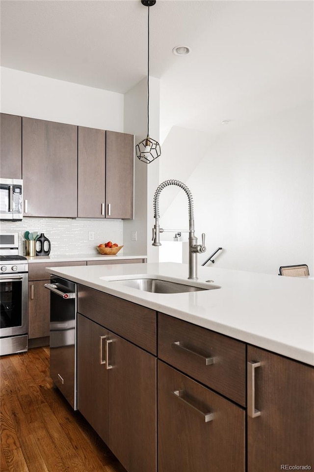 3308 W 17th Ave, Denver, CO 80204 - kitchen with stainless steel appliances, light countertops, dark wood finished floors, and dark brown cabinets