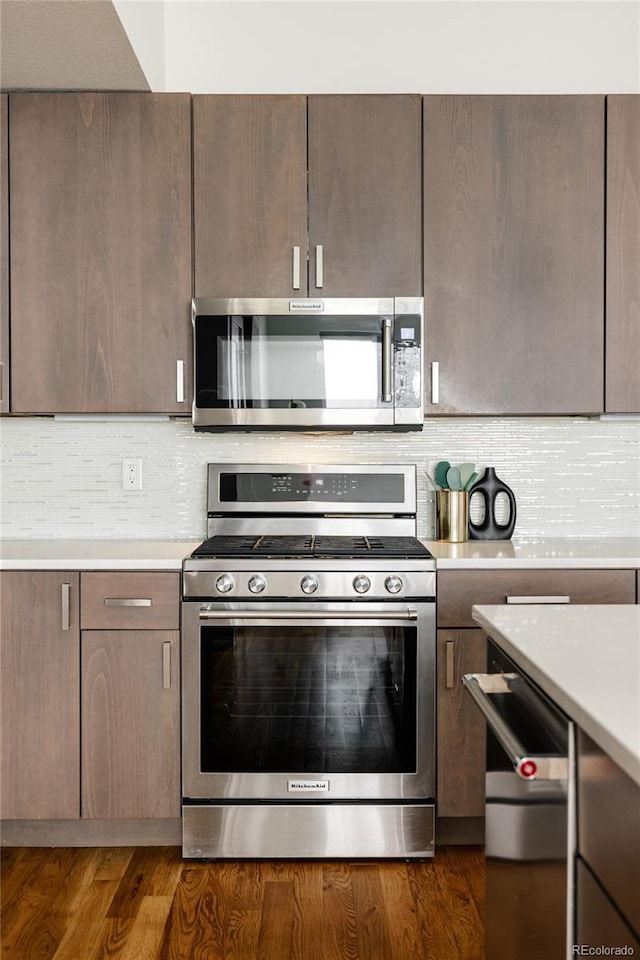 3308 W 17th Ave, Denver, CO 80204 - kitchen with stainless steel appliances, light countertops, decorative backsplash, and dark wood finished floors