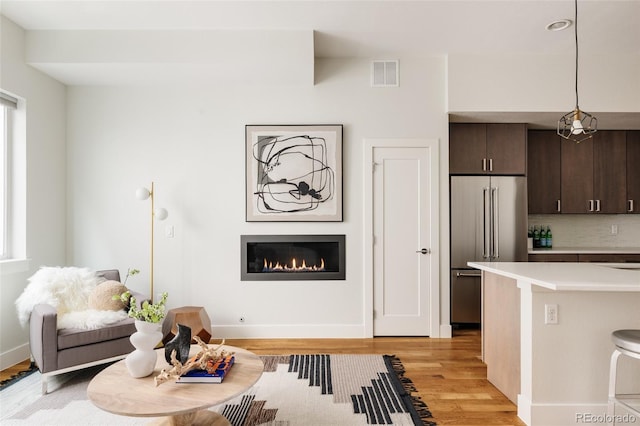 3308 W 17th Ave, Denver, CO 80204 - living room featuring a glass covered fireplace and light wood-style flooring