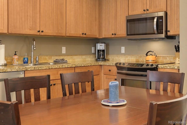 kitchen with appliances with stainless steel finishes and a sink