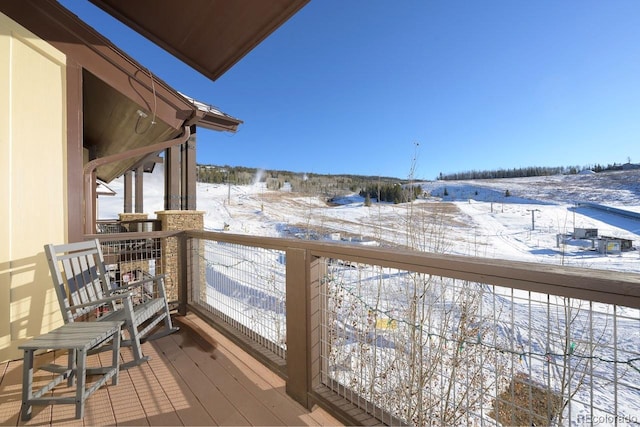 view of snow covered back of property