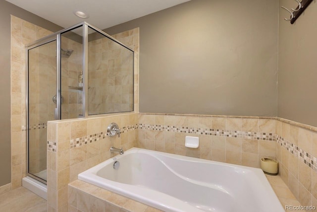 full bathroom featuring a shower stall and a bath