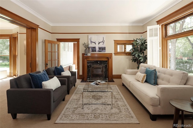 carpeted living room with ornamental molding and a premium fireplace