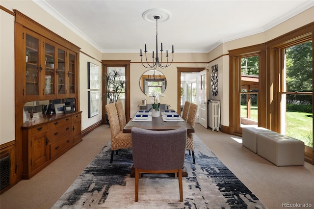 dining room featuring light colored carpet, a notable chandelier, and ornamental molding